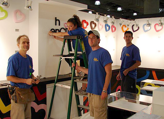 the team at Manny Stone Decorators, building a trade show booth